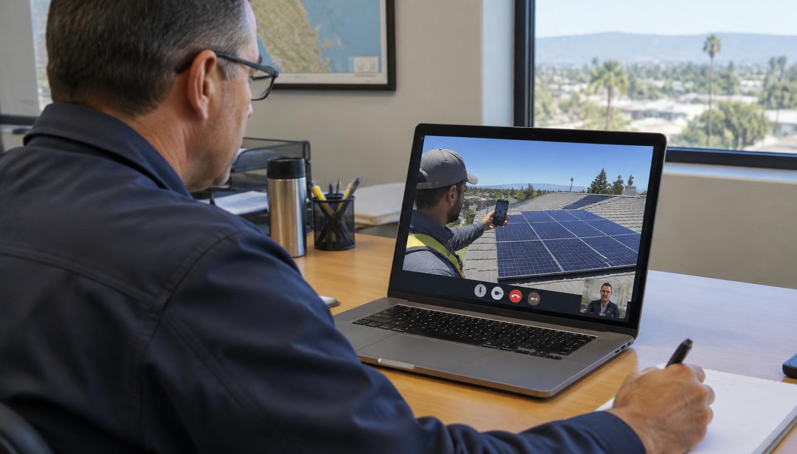 Building inspector conducting a remote virtual inspection of a rooftop solar installation over a live video call under California AB 1738